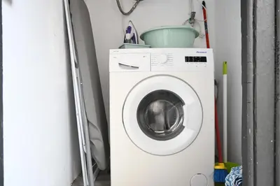 a washing machine with a bucket on top of it at Homenfun Barcelona Camp Nou in Hospitalet de Llobregat