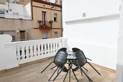 a balcony with two chairs and a table at Homenfun Barcelona Camp Nou in Hospitalet de Llobregat