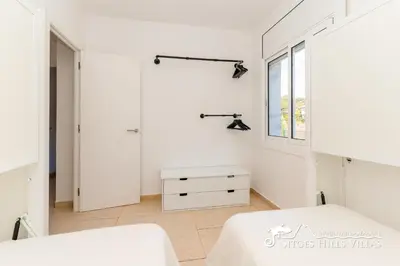 a dining room with a table and chairs and windows at Sunny Villa Moments near Sitges in Olivella