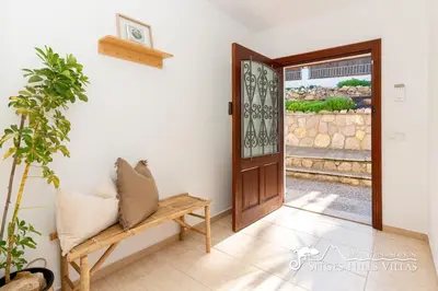 a room with a door and a bench and a window at Sunny Villa Moments near Sitges in Olivella