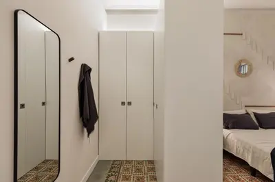 a hallway with white walls and a mirror on a wall at Savegre - 3 bedrooms in Eixample Esquerra in Barcelona