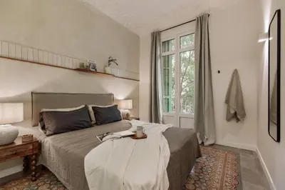 a bedroom with a bed and a room with a table at Savegre - 3 bedrooms in Eixample Esquerra in Barcelona