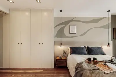 a bedroom with a large bed and a living room at Cabuy - 1 bedroom in La Dreta de l'Eixample in Barcelona