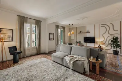 a living room with a wooden table and chairs at Mirra - 5 bedrooms and terrace in Eixample Dreta in Barcelona