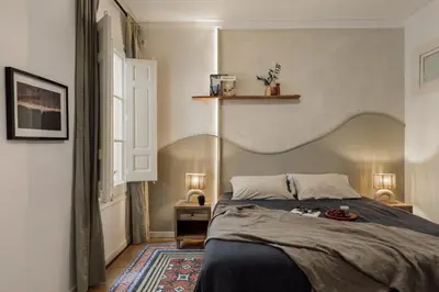 a bedroom with a large bed and a mirror at Mirra - 5 bedrooms and terrace in Eixample Dreta in Barcelona