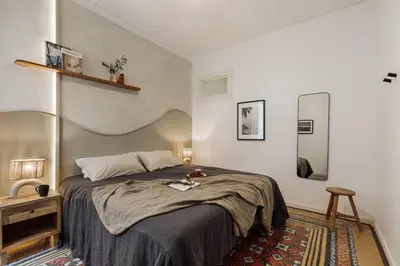 a white bedroom with a bed and a door at Mirra - 5 bedrooms and terrace in Eixample Dreta in Barcelona