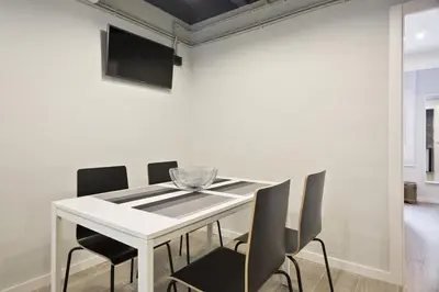 a white dining room with a white table and chairs at Stay U-nique Apartments Llobregat in Hospitalet de Llobregat
