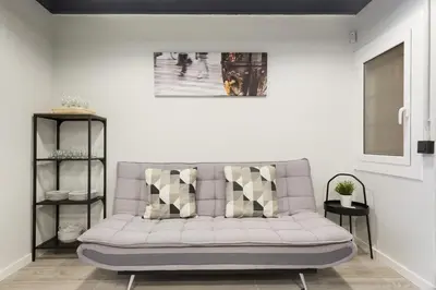 a living room with a gray couch in a room at Stay U-nique Apartments Llobregat in Hospitalet de Llobregat