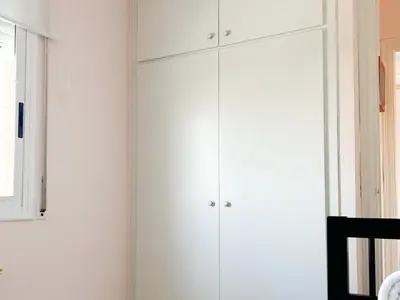 a room with white cabinets and a window at Apartment Sunset in Cunit