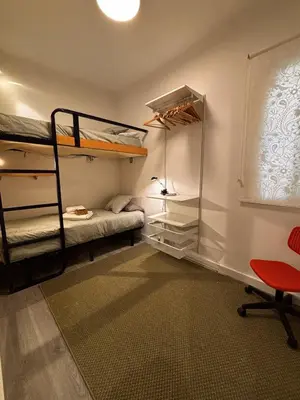 a room with two bunk beds and a desk at Full flat in the heart of Barcelona in Barcelona