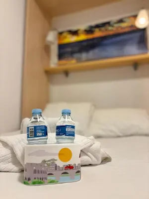two bottles of water sitting on top of a bed at Full flat in the heart of Barcelona in Barcelona