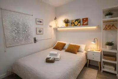 a small bedroom with a bed with towels on it at Full flat in the heart of Barcelona in Barcelona