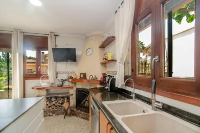 a kitchen with a sink and a stove at Casa con piscina salina a 5 minutos de Sitges in Canyelles
