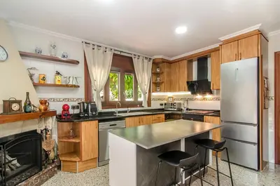 a kitchen with a refrigerator and a stove at Casa con piscina salina a 5 minutos de Sitges in Canyelles