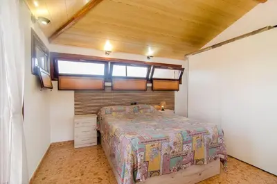 a bedroom with a bed and a wooden ceiling at Casa con piscina salina a 5 minutos de Sitges in Canyelles