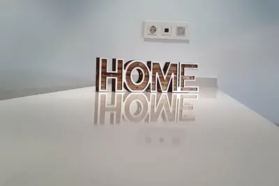 a white table with a sign that reads home home have at Rooftop pool near the beach and Barcelona in Masnou