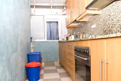 a small kitchen with a sink and a stove at 3rooms, 10 minAirport, free parking, public transp in Cornellà de Llobregat