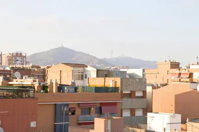 a city with buildings and mountains in the background at 3rooms, 10 minAirport, free parking, public transp in Cornellà de Llobregat