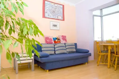 a blue couch in a living room with a table at 3rooms, 10 minAirport, free parking, public transp in Cornellà de Llobregat