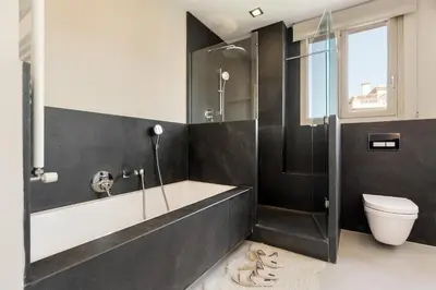 a bathroom with a tub and a toilet and a shower at Enjoy Apartments Augustina's Grand Family Suite in Barcelona