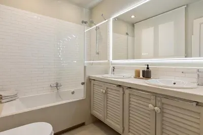a bathroom with two sinks and a tub and a mirror at Enjoy Apartments Augustina's Grand Family Suite in Barcelona