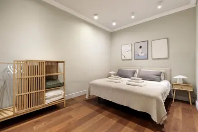 a bedroom with a bed and a book shelf at Enjoy Apartments Augustina's Grand Family Suite in Barcelona