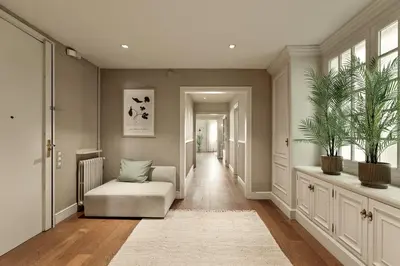 a hallway with a chair and plants in it at Enjoy Apartments Augustina's Grand Family Suite in Barcelona