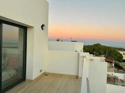 a view from the balcony of a white house at Les Flors de Cunit Villa Edelweiss in Cunit