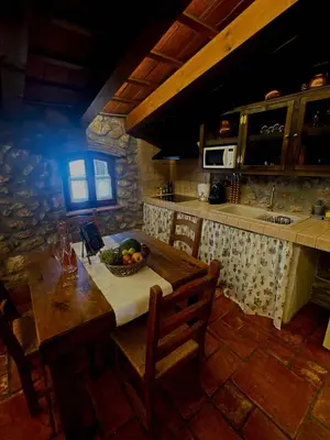 a kitchen with a table with a bowl of fruit on it at Mas del Drac in Castellví de la Marca