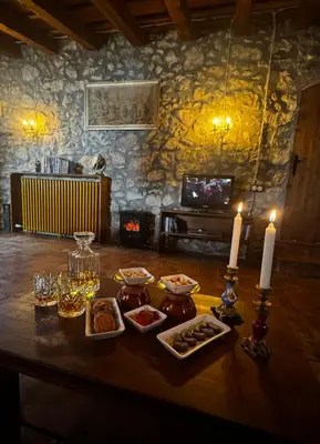 a table with food and candles on top of it at Mas del Drac in Castellví de la Marca