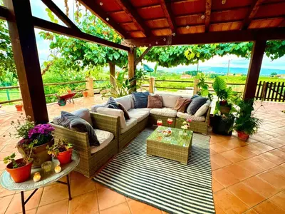a patio with a couch and a table with plants at Mas del Drac in Castellví de la Marca
