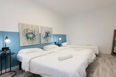 a group of four beds in a room at matarolux21 in Mataró