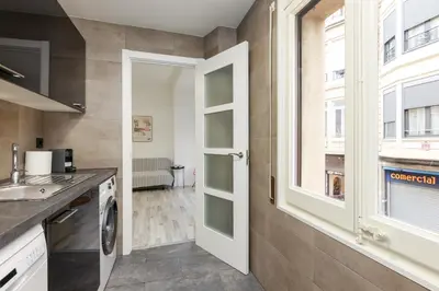 a kitchen with a sink and a window at matarolux21 in Mataró