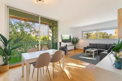 a living room with a white table and chairs at Modern Spacious 3-Bedroom Apt with Pool near Beach in Barcelona