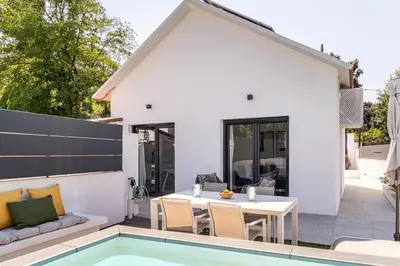 a patio with a table and chairs and a pool at The Sweet House - BBQ y piscina in Sant Cugat del Vallès
