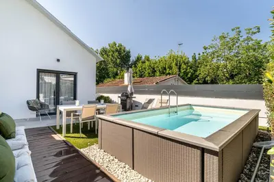 a backyard with a swimming pool and a table and a house at The Sweet House - BBQ y piscina in Sant Cugat del Vallès