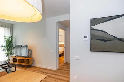 a living room with a television and a painting on the wall at Brabo Apartments in Hospitalet de Llobregat