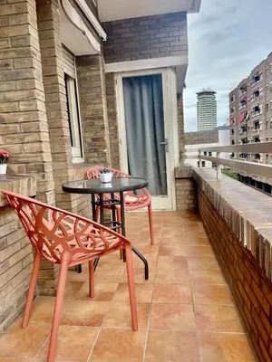 a patio with a table and a chair on a balcony at Apartamento vacaciones Barcelona in Barcelona