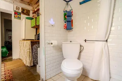 a bathroom with a white toilet in a room at Vintage home in Barcelona