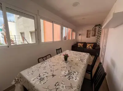 a room with a table with a vase of flowers on it at Apartamento Fira Barcelona, 20' Barcelona centro, 4 hab - 8 pers in Hospitalet de Llobregat