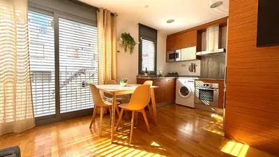 a kitchen with a table and chairs in a room at Acogedor apartamento by Prestigi in Terrassa