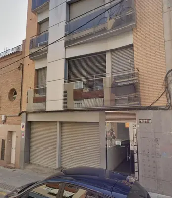 a car parked in front of a building with garage doors at Acogedor apartamento by Prestigi in Terrassa