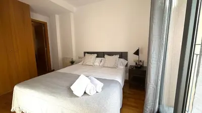 a bedroom with a white bed with towels on it at Acogedor apartamento by Prestigi in Terrassa