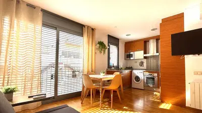 a kitchen and dining room with a table and chairs at Acogedor apartamento by Prestigi in Terrassa