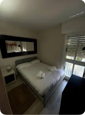 a bedroom with a bed with two towels on it at Ocean View Sunny Beach Apartment Castelldefels in Castelldefels