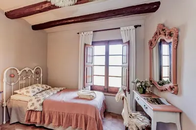 a bedroom with a bed and a mirror at Montrural in Castellví de la Marca