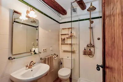 a bathroom with a sink and a toilet and a mirror at Montrural in Castellví de la Marca