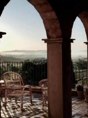 two chairs sitting on a patio with a view at Montrural in Castellví de la Marca