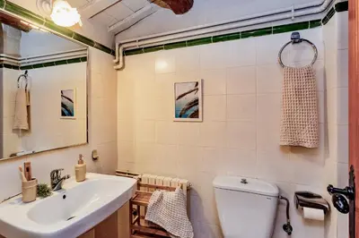 a bathroom with a sink and a toilet and a mirror at Montrural in Castellví de la Marca