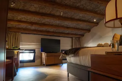 a bedroom with a bed and a flat screen tv at Boada Riera - The RoomsbyReini in Terrassa